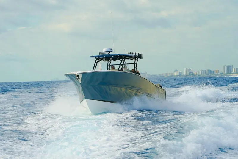 Slide: The Image of SeaWell 345XL boat cruising on ocean waves, city skyline in background, 2025 model. - 17