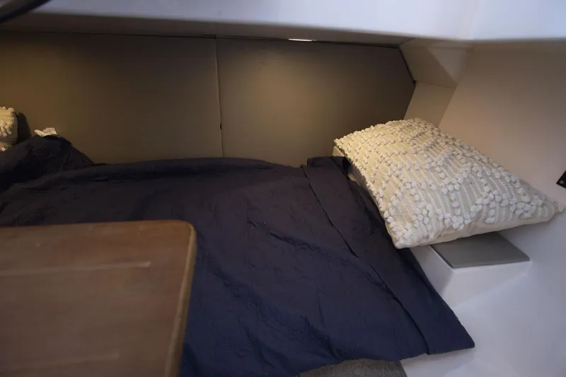 Slide: The Image of Cozy cabin interior of 2025 SeaWell 345XL with navy bedding and textured pillow. - 20
