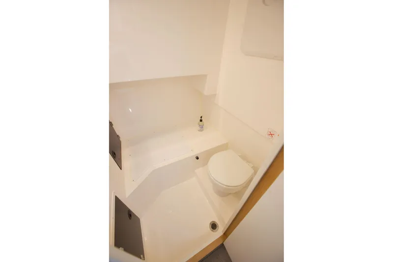 Slide: The Image of Compact bathroom in 2025 SeaWell 345XL boat, featuring a toilet and storage space. - 27