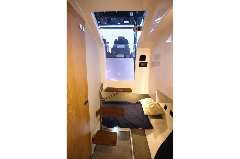 Slide: The Image of Compact cabin interior of 2025 SeaWell 345XL boat with bed and wooden steps. - 30