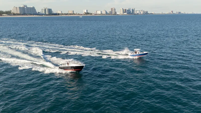 Slide: The Image of Two SeaWell 290XL boats cruising on the ocean near a city skyline, 2025 model. - 28