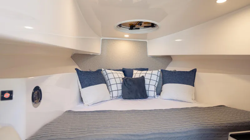 Slide: The Image of Cozy cabin interior of 2025 SeaWell 290XL boat with stylish pillows and modern design. - 29