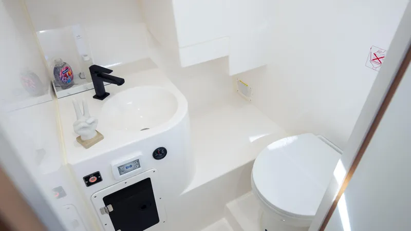 Slide: The Image of Compact bathroom in 2025 SeaWell 290XL boat with sink, faucet, and toilet. - 31