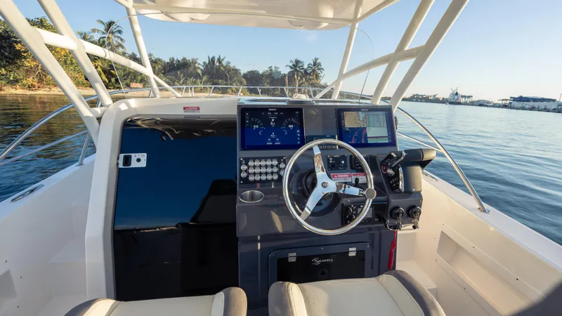 Slide: The Image of 2025 SeaWell 290XL boat cockpit with modern controls, steering wheel, and ocean view. - 38