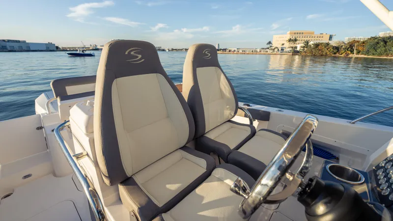 Slide: The Image of 2025 SeaWell 290XL boat interior with dual seats, steering wheel, and waterfront view. - 40