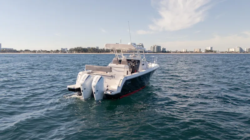 Slide: The Image of 2025 SeaWell 290XL boat cruising on open water with twin engines. - 5