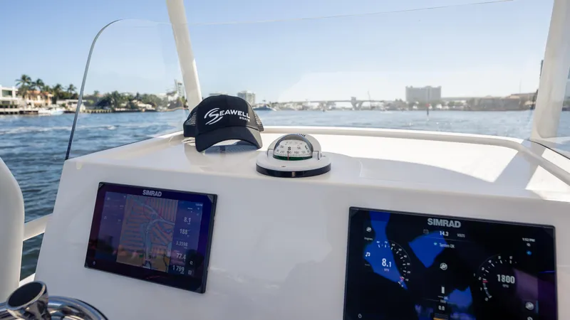 Slide: The Image of Cockpit view of 2025 SeaWell 290XL boat with navigation screens and compass. - 9