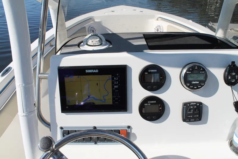 Slide: The Image of 2024 Key West 203 FS boat dashboard with navigation and control instruments. - 13