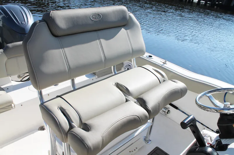 Slide: The Image of 2024 Key West 203 FS boat interior with comfortable seating and steering wheel by the water. - 15