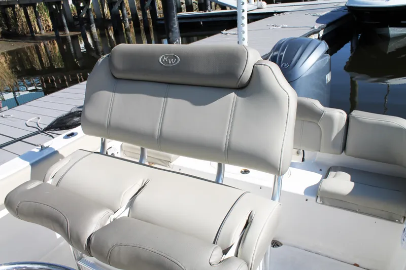 Slide: The Image of 2024 Key West 203 FS boat interior with cushioned seating and Yamaha engine. - 16