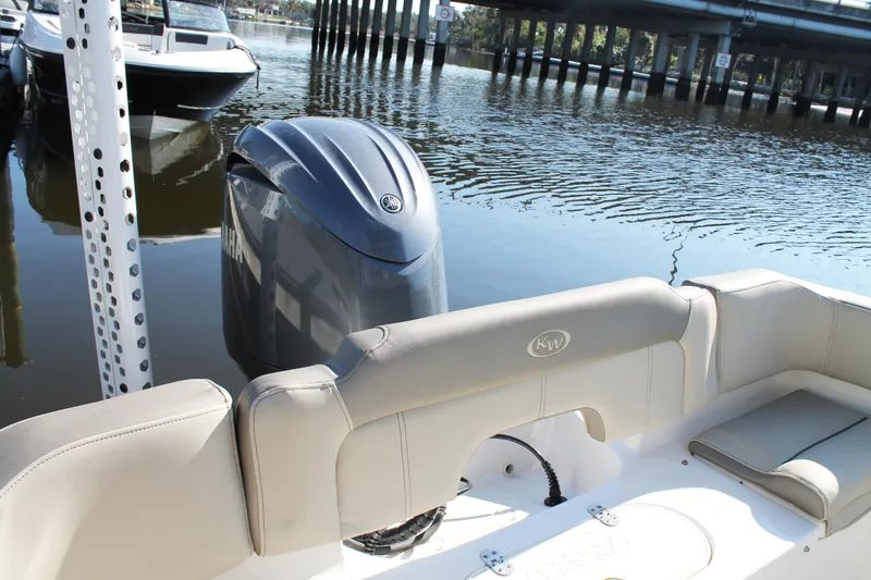 Slide: The Image of 2024 Key West 203 FS boat with Yamaha engine, docked on calm water. - 18