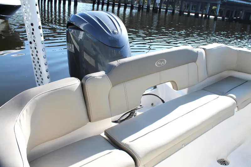 Slide: The Image of 2024 Key West 203 FS boat with Yamaha engine, featuring comfortable seating by the water. - 19