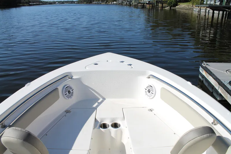 Slide: The Image of 2024 Key West 203 FS boat interior with seating and cup holders on calm water. - 24