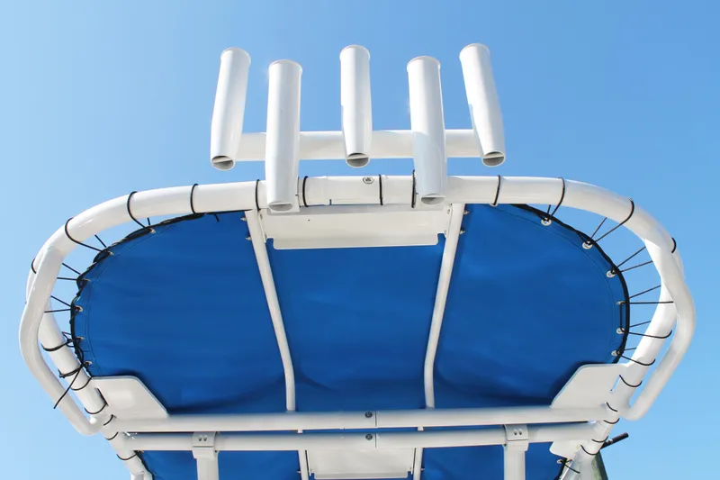 Slide: The Image of 2024 Key West 203 FS boat canopy with rod holders against clear blue sky. - 27