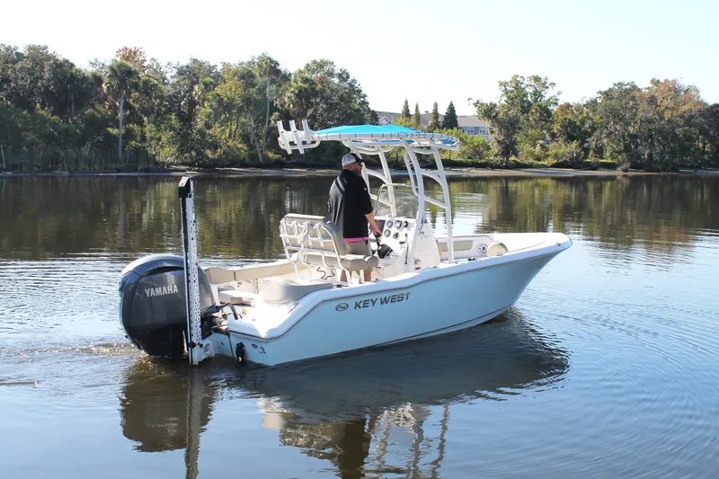Slide: The Image of 2024 Key West 203 FS boat cruising on a calm lake with Yamaha engine. - 4