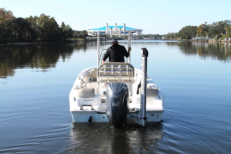 Slide: The Image of 2024 Key West 203 FS boat cruising on a calm river with scenic surroundings. - 6
