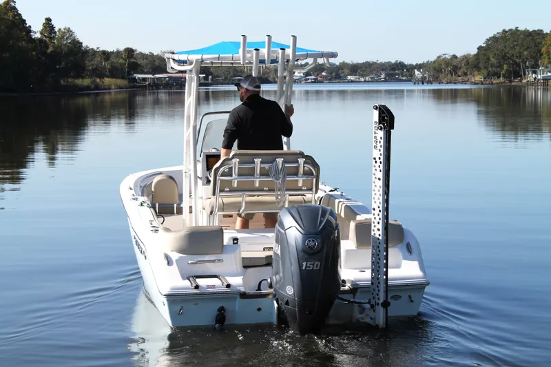 Slide: The Image of 2024 Key West 203 FS boat cruising on a calm lake with a blue canopy. - 7