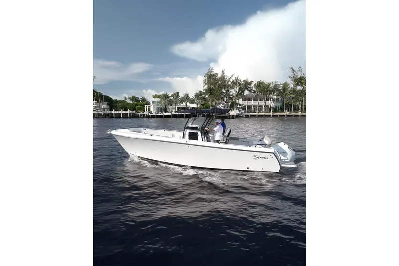 The Image of 2026 SeaWell 290CC boat cruising on a calm waterway near a lush shoreline. - 0