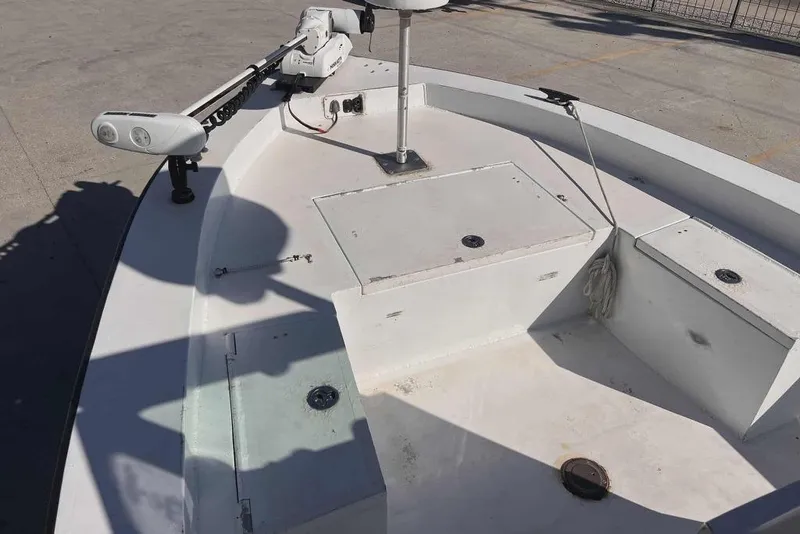 Slide: The Image of 1997 Gravois 20CC boat deck with storage compartments and trolling motor. - 12