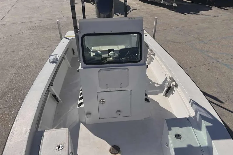 Slide: The Image of 1997 Gravois 20CC boat interior with console and seating, docked on concrete surface. - 15
