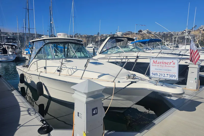 Slide: The Image of 2001 Pursuit 3000 Express boat docked at marina with brokerage sign. - 2