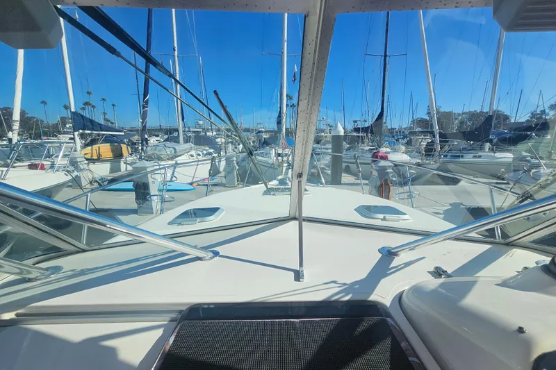 Slide: The Image of 2001 Pursuit 3000 Express boat docked in a marina with clear blue skies. - 21