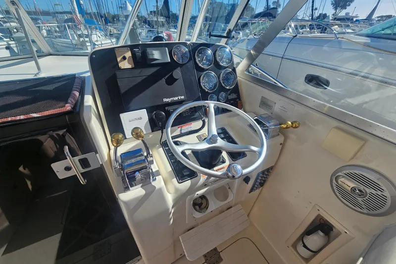 Slide: The Image of Helm of 2001 Pursuit 3000 Express boat with steering wheel and navigation instruments. - 22