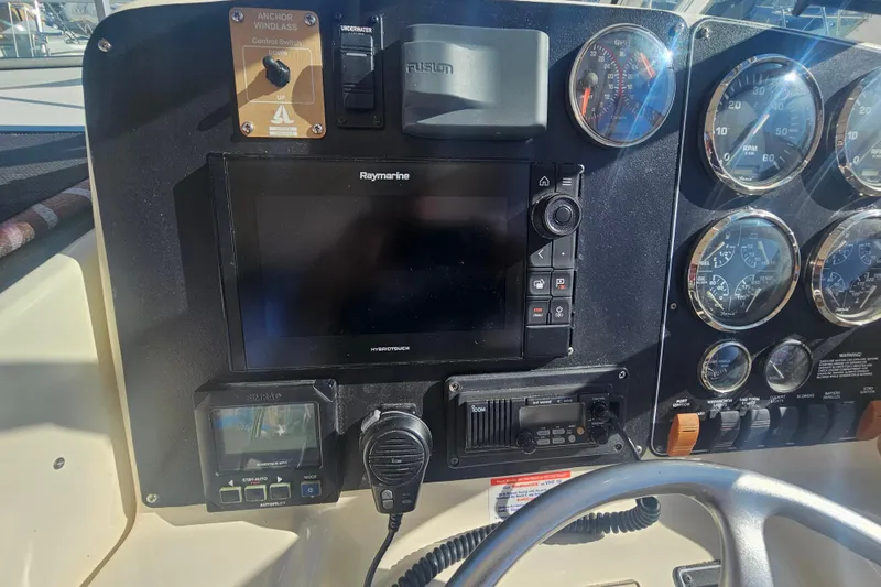 Slide: The Image of Control panel of a 2001 Pursuit 3000 Express boat with navigation and communication equipment. - 24
