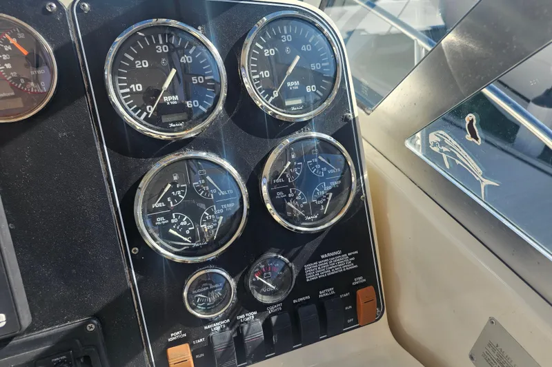 Slide: The Image of Dashboard of a 2001 Pursuit 3000 Express boat with various gauges and controls. - 25