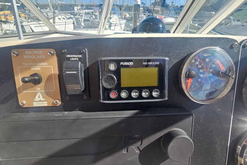 Slide: The Image of Control panel of a 2001 Pursuit 3000 Express boat with gauges and switches. - 26