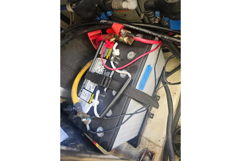 Slide: The Image of Battery compartment of a 2001 Pursuit 3000 Express boat with connected cables. - 27