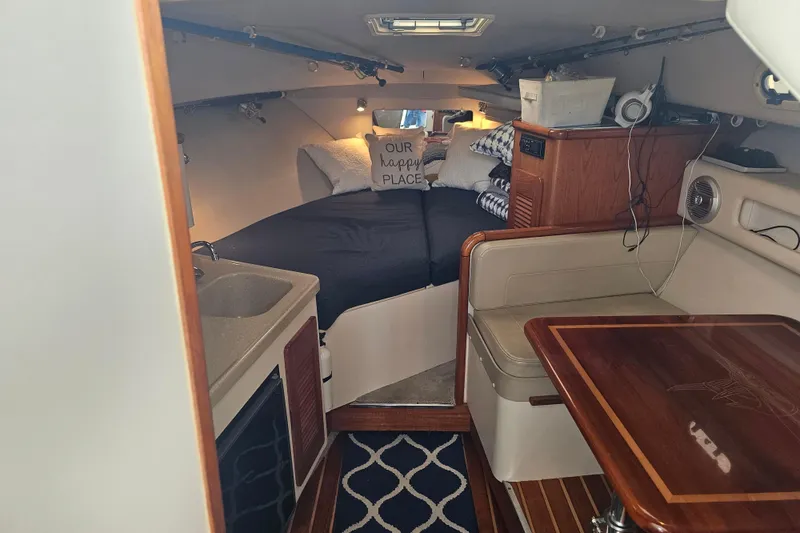 Slide: The Image of Interior of 2001 Pursuit 3000 Express boat with cozy cabin and dining area. - 33