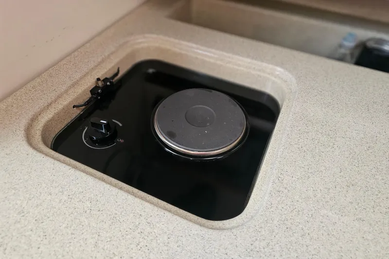 Slide: The Image of Electric stove on 2001 Pursuit 3000 Express boat, featuring a sleek countertop design. - 39