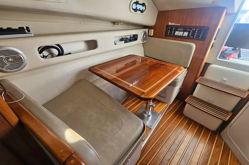Slide: The Image of 2001 Pursuit 3000 Express cabin interior with wooden table and seating area. - 43