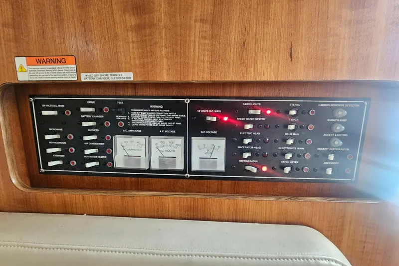 Slide: The Image of Control panel of a 2001 Pursuit 3000 Express boat with various switches and gauges. - 48