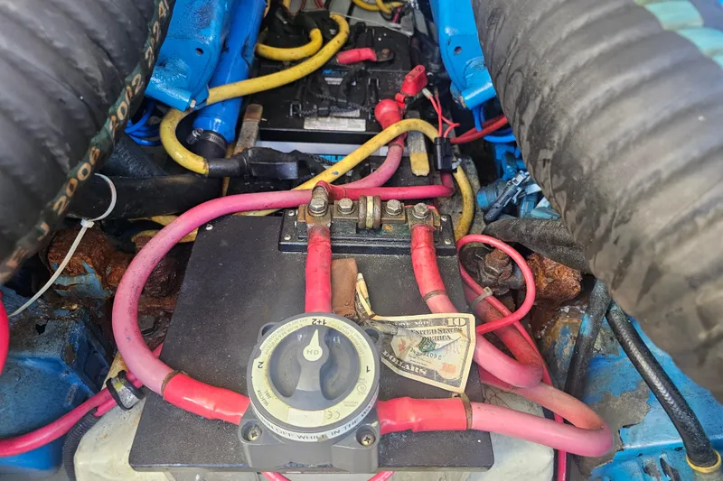 Slide: The Image of Engine compartment of a 2001 Pursuit 3000 Express with visible wiring and components. - 49
