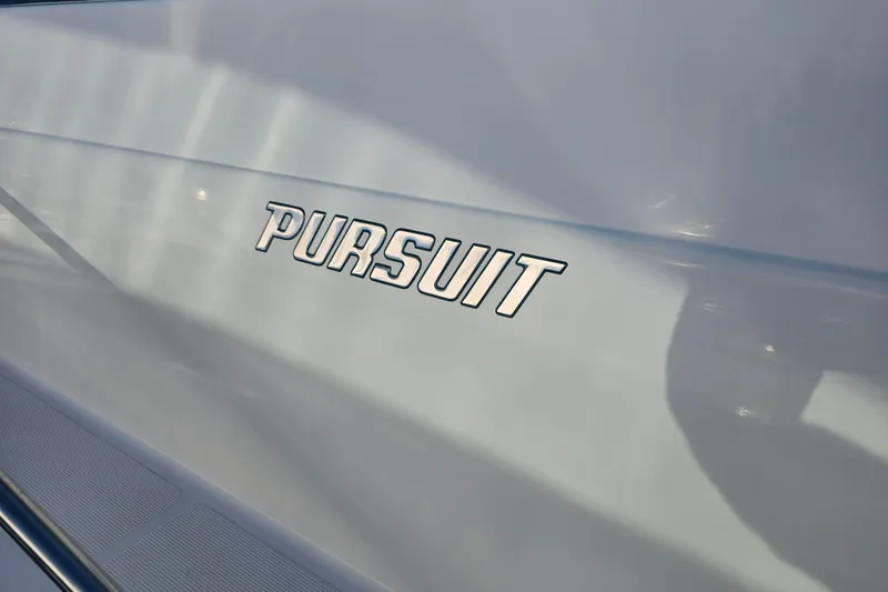 Slide: The Image of Close-up of 2001 Pursuit 3000 Express boat logo on sleek surface. - 5