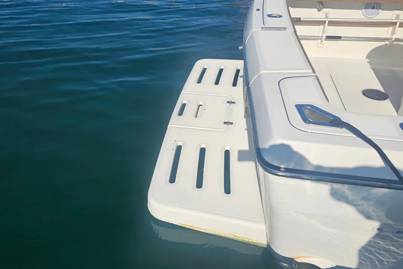 Slide: The Image of 2001 Pursuit 3000 Express boat with swim platform on calm water. - 6