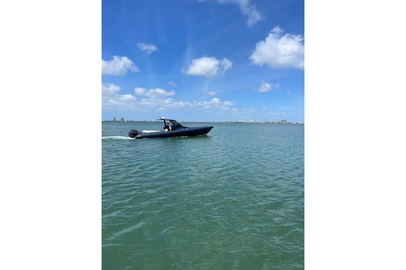 Slide: The Image of 2024 Skipper 42 boat cruising on a sunny day with blue skies and calm waters. - 14