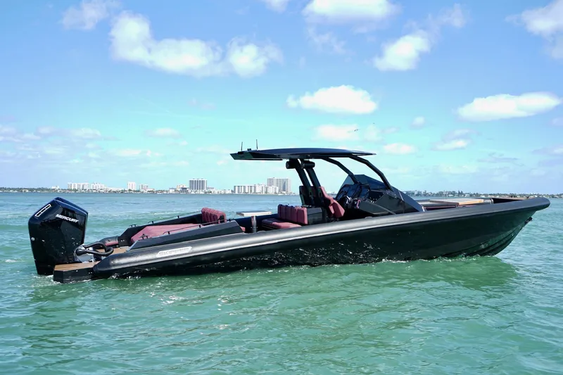 Slide: The Image of 2024 Skipper 42 boat on water, sleek design, sunny day, city skyline in background. - 22