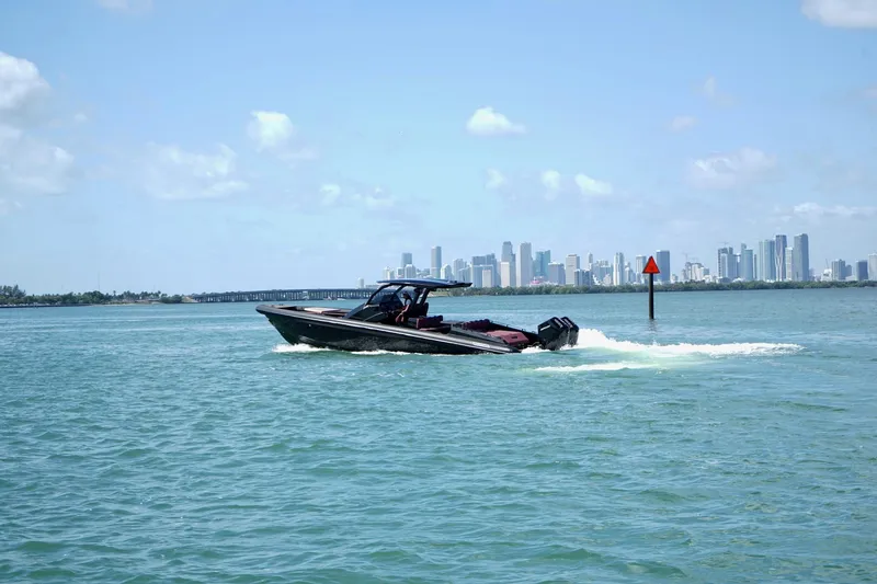 Slide: The Image of 2024 Skipper 42 boat cruising on water with city skyline in background. - 29