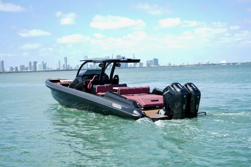 Slide: The Image of 2024 Skipper 42 boat cruising on water with city skyline in background. - 32