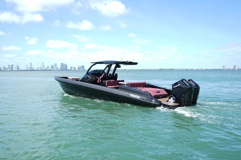 Slide: The Image of 2024 Skipper 42 boat cruising on open water with city skyline in background. - 33