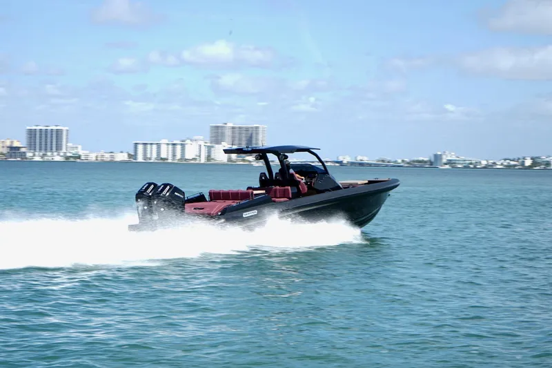 Slide: The Image of 2024 Skipper 42 speedboat cruising on water with city skyline in background. - 36