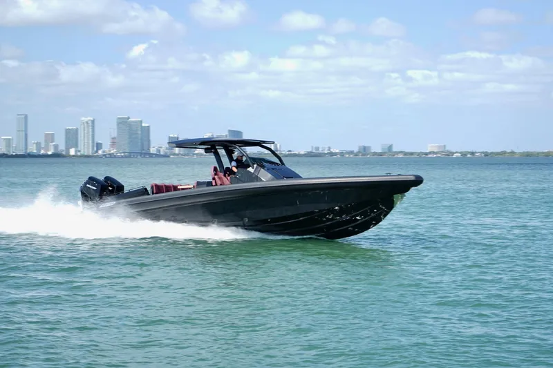 Slide: The Image of 2024 Skipper 42 boat cruising on water with city skyline in background. - 37