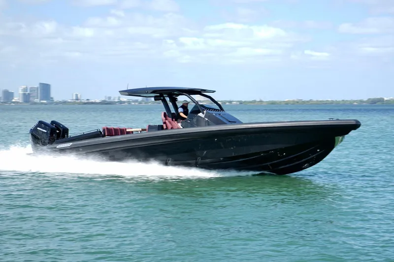 Slide: The Image of 2024 Skipper 42 boat cruising on water with city skyline in background. - 40