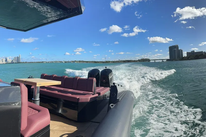 Slide: The Image of Luxurious 2024 Skipper 42 yacht cruising on a sunny day with city skyline views. - 47