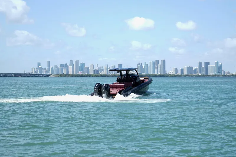 Slide: The Image of 2024 Skipper 42 boat cruising on water with city skyline in background. - 15