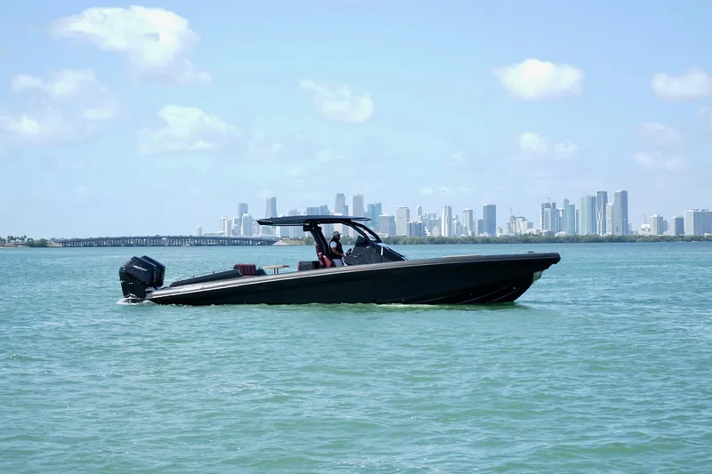 Slide: The Image of 2024 Skipper 42 boat cruising on water with city skyline in background. - 17