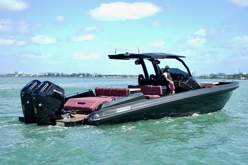 Slide: The Image of 2024 Skipper 42 boat cruising on water with dual Mercury engines. - 23